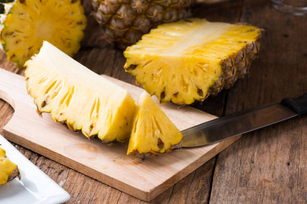 istock pineapple on the wood  background 967374532