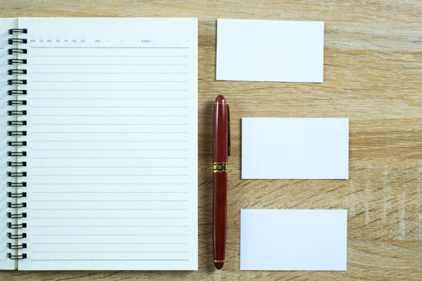 istock Blank business card or name card with space for add text name address and logo with notebook organizer on working table, financial company concept. top view. 967374738