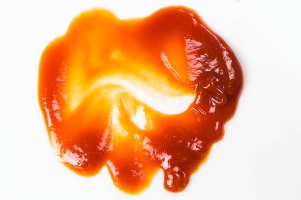 istock Tomato sauce isolated on white background. Red ketchup splashes isolated on white background, top view 967377994
