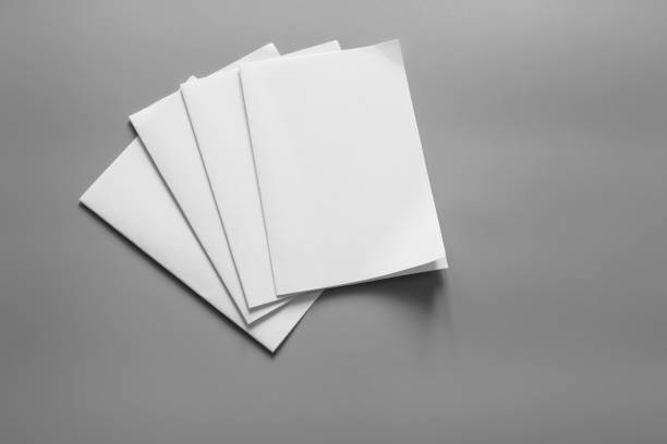 istock Blank portrait mock-up paper. brochure magazine isolated on gray, changeable background / white paper isolated on gray 967410562