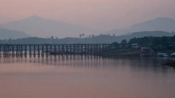 This Wooden Mon Bridge is officially named Uttama Nusorn Bridge with sun light in ter morning. It was built in order to connect with Mon village and Songalia village in Kanchanaburi , Thailand