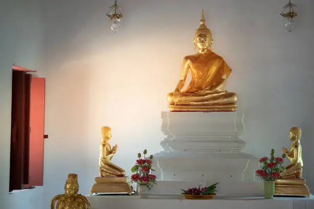Beautiful of golden old Buddha statue in church at  Wat Lom Mahachai Chumphon, Rayong, Thailand.