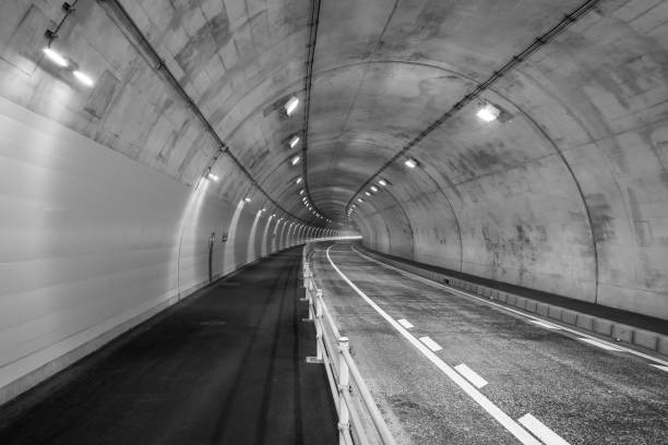 istock highway road tunnel in black and white background 967434446
