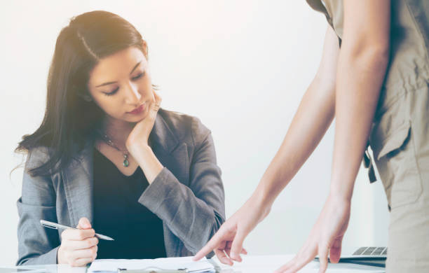 istock Businesswoman reads and talks with partner. 967438024