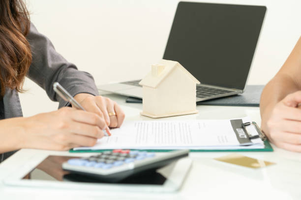 istock Client Signs Document to Buy House and Real Estate 967438034