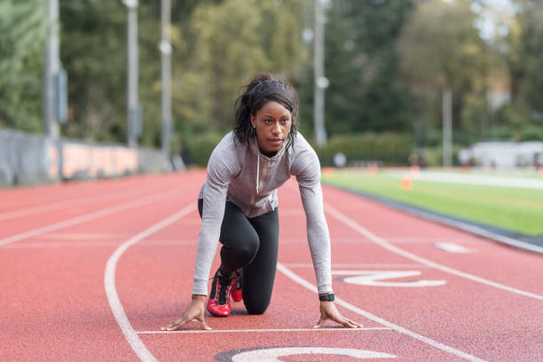 istock Female track athlete training at stadium 967439040