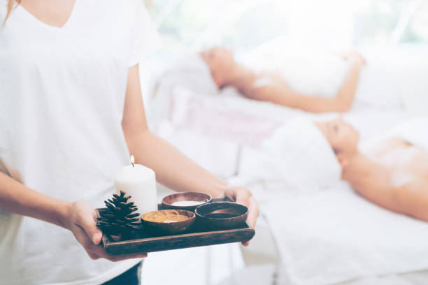 istock Massage therapist with hot spa treatment set. 967439342