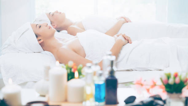istock Relaxed young woman lying on spa bed for massage. 967439386