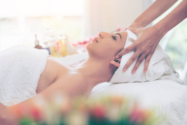 istock Relaxed young woman lying on spa bed for massage. 967439412