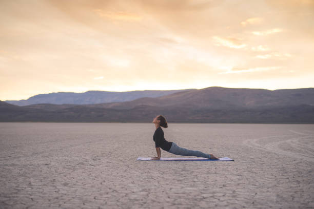 istock Ethnic woman doing yoga in the desert 967439912