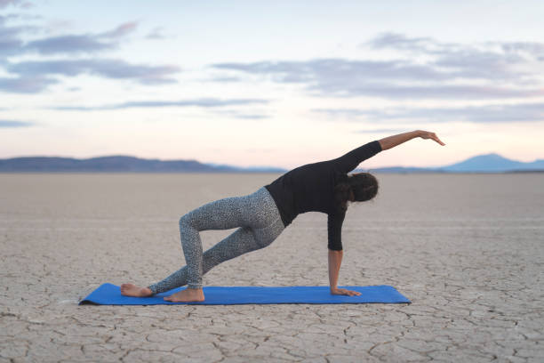 istock Ethnic woman doing yoga in the desert 967439934
