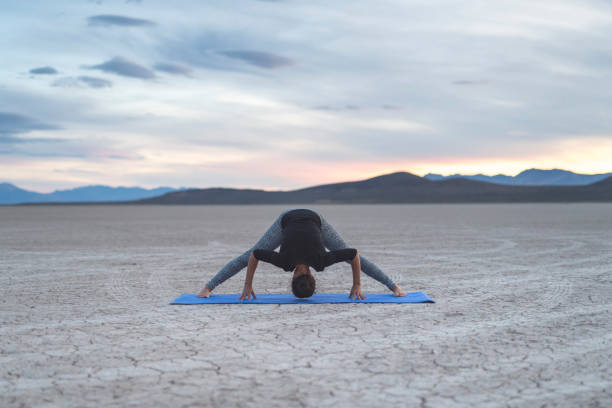 istock Ethnic woman doing yoga in the desert 967439940