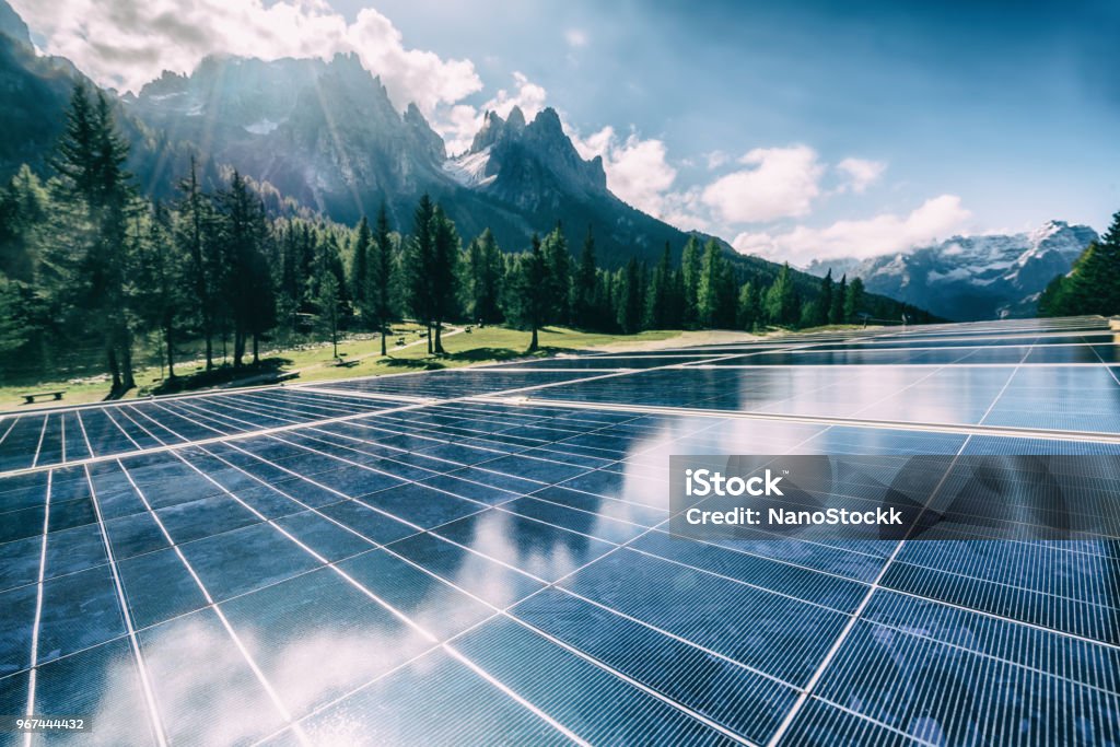 Solar cell panel in country mountain landscape. Solar cell panel in country landscape against sunny sky and mountain backgrounds. Solar power is the innovation for sustainability of world energy. Sustainable resources. Fuel and Power Generation Stock Photo