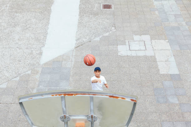 istock Young man playing basketball in public park 967487734