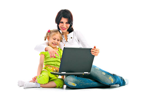 ma and daughter with laptop stock photo