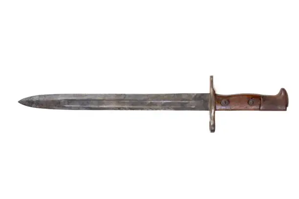 Vintage US Army bayonet from either the Boxer Rebellion or Phillippine American War eras, early 1900s, used as accessory to a Krag-Jorgensen rifle, isolated on white
