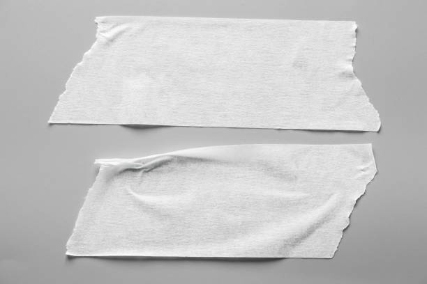 istock Set of white tapes on gray background. Torn horizontal and different size White sticky tape, adhesive pieces. 967500360