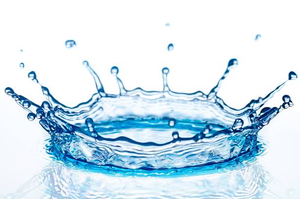Blue splash of water with smaller drops around on white back stock photo