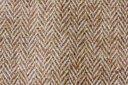 Dark brown and white fabric texture useful as a background.