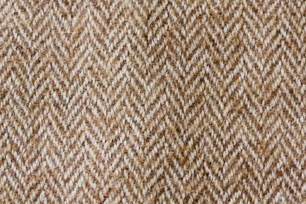 Dark brown herringbone fabric swatch. Dark brown and white fabric texture useful as a background. tweed stock pictures, royalty-free photos & images