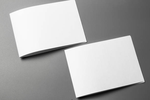 istock Blank portrait mock-up paper. brochure magazine isolated on gray, changeable background / white paper isolated on grey 967521354
