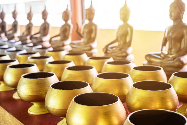istock monk's alms bowl and buddha statue for largess 967526212