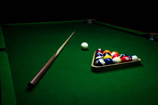 istock Playing billiard. Billiards balls and cue on green billiards table. 967530530