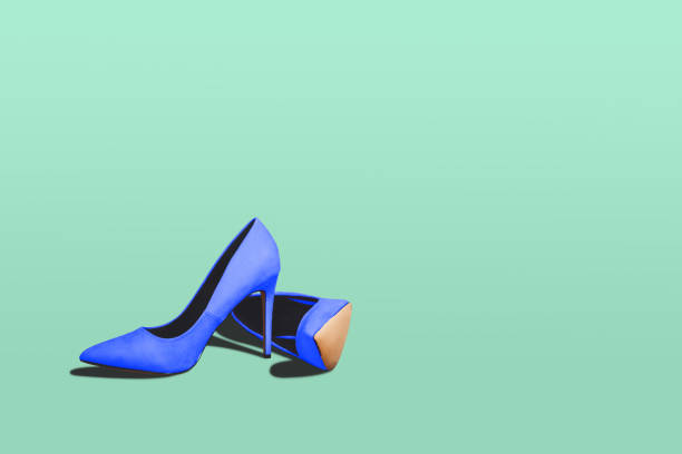 istock Blue high heels isolated on a bright green pastel background. 967535220