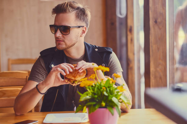 istock A man eating a vegan burger. 967539374