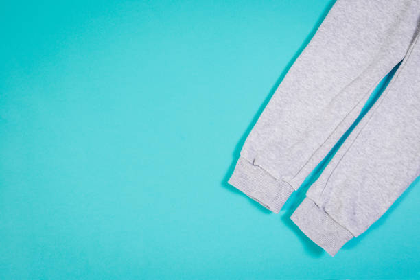 istock Top view of sweat pants on turquoise pastel background. 967542828