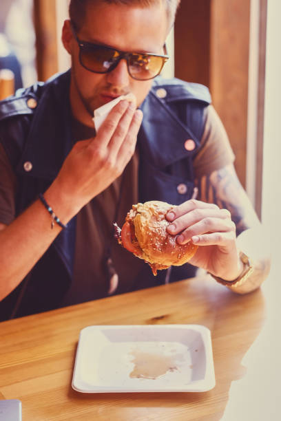 istock A man eating a vegan burger. 967544260