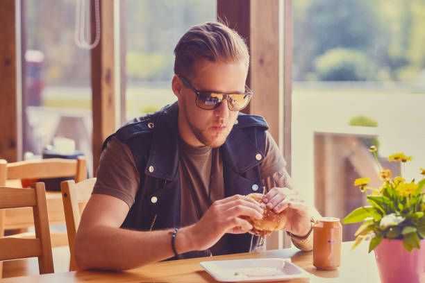 istock A man eating a vegan burger. 967544390