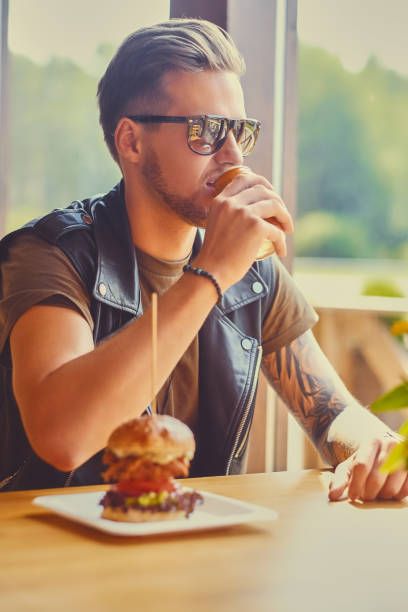 istock A man eating a vegan burger. 967548976