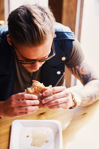 istock A man eating a vegan burger. 967549402