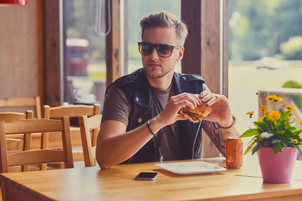 istock A man eating a vegan burger. 967551720