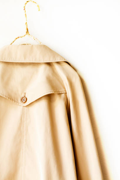 istock the back of a beige elegant trench coat isolated over white 967552604