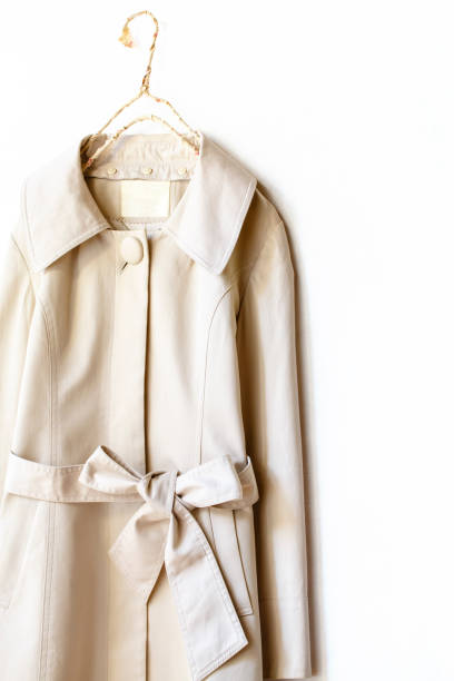 istock Beige or greige elegant trench coat with ribbon isolated over white 967552944