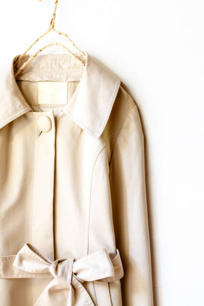 istock Beige or greige elegant trench coat with ribbon isolated over white 967552998