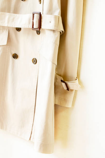 istock Beige elegant trench coat with belt isolated over white 967553048