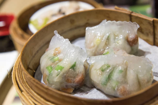 istock Dim Sum, traditional Cantonese dumplings, cooked in bamboo steamer 967553088