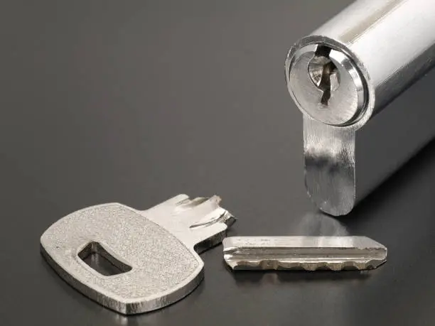 Photo of Pin tumbler of cylinder lock internal mechanism and broken key with copy space