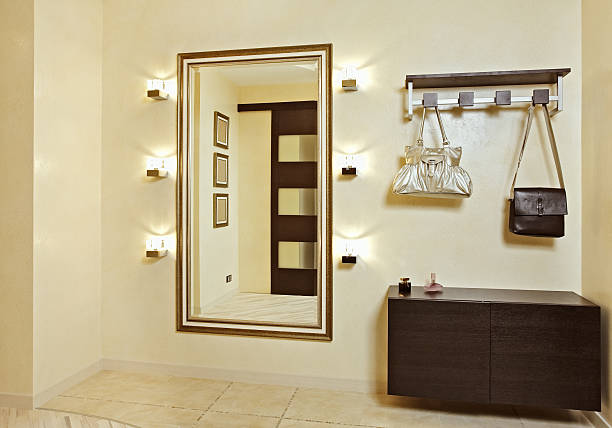 Hall in beige tones with hall-stand and golden mirror stock photo