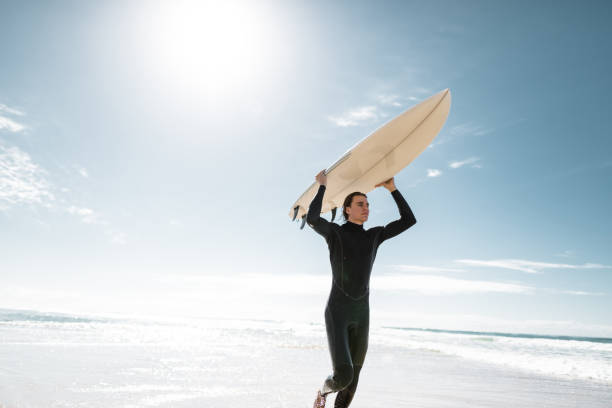 istock surfer walking in surfers paradise beach in australia 967607140
