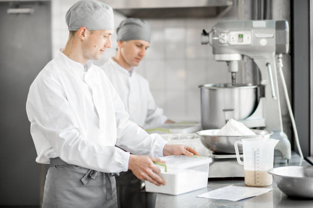 istock Confectioner working at the bakery manufacturing 967627198