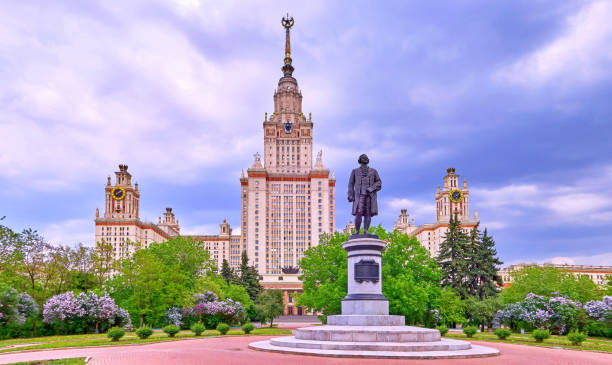 istock Multicoloured lilac trees in spring in the campus of Moscow university under dramatic sky 967630596