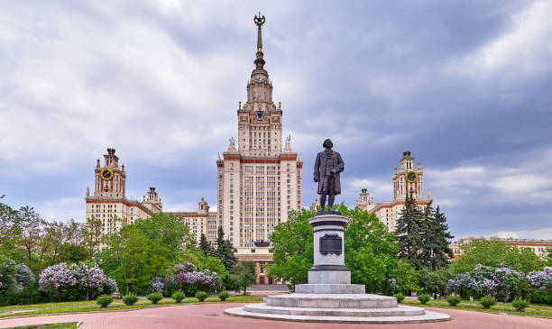istock Multicoloured lilac trees in spring in the campus of Moscow university under dramatic sky 967630656