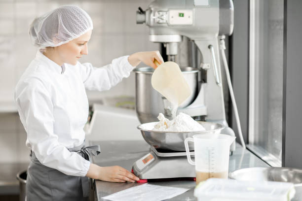 istock Woman confectioner working at the bakery manufacturing 967632932