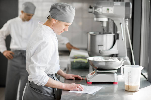 istock Confectioners working at the bakery manufacturing 967637900