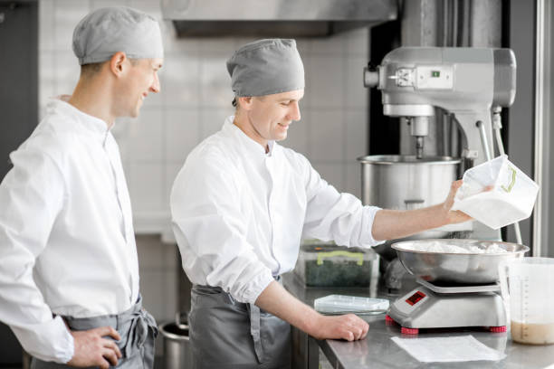 istock Confectioners working at the bakery manufacturing 967640050