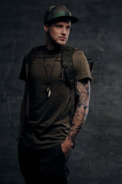 istock Backpacker in Camo green t shirt and tattoos on arms. 967646664